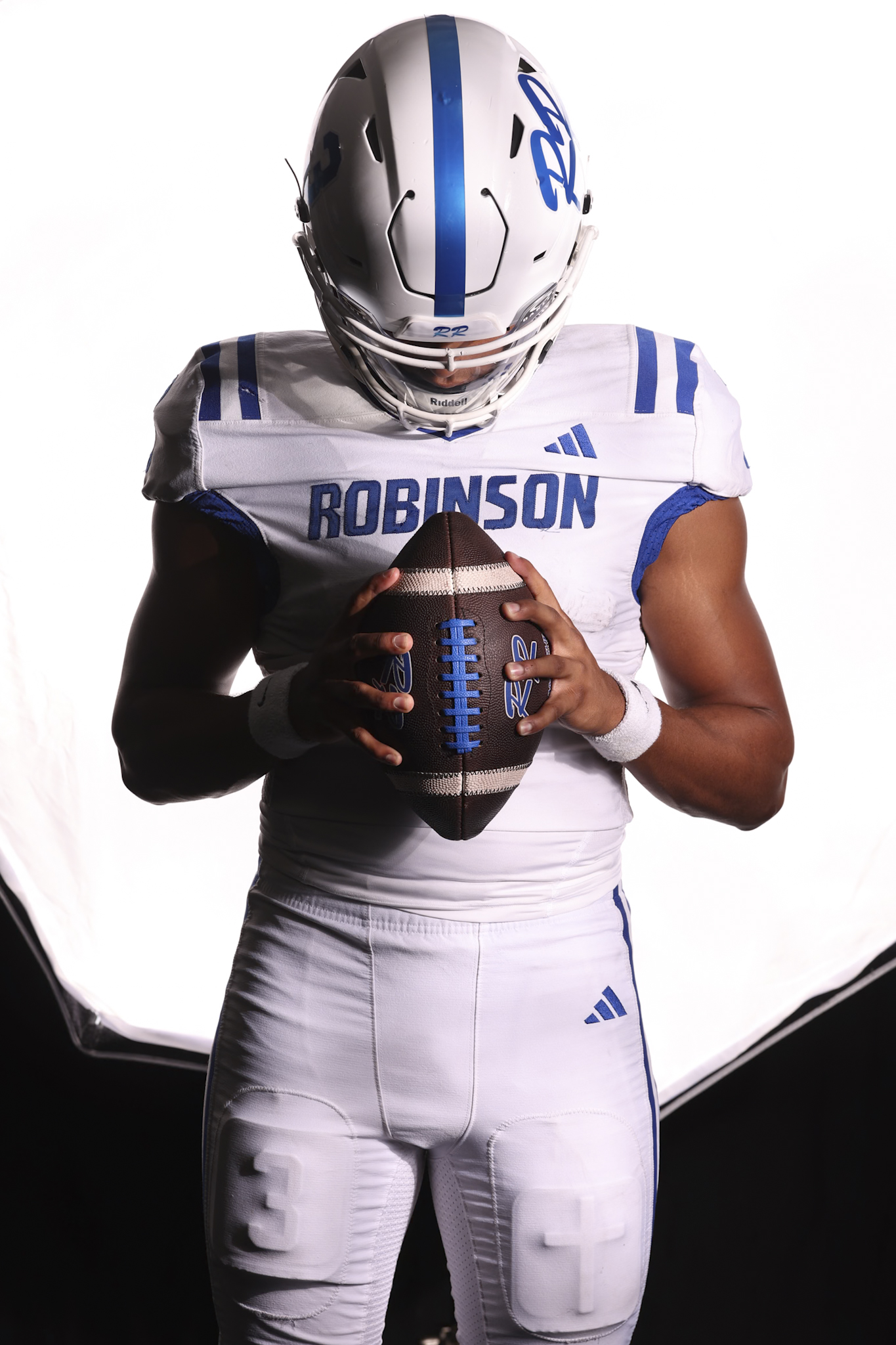 Robinson senior quarterback Brice McCurdy holding a football